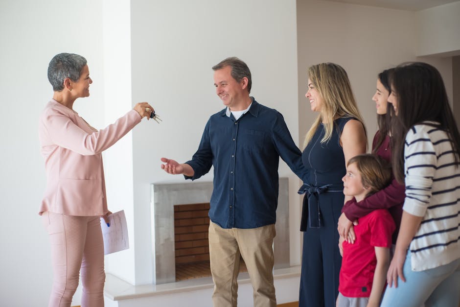 A joyful family receives keys to their new home from a realtor inside a modern house.