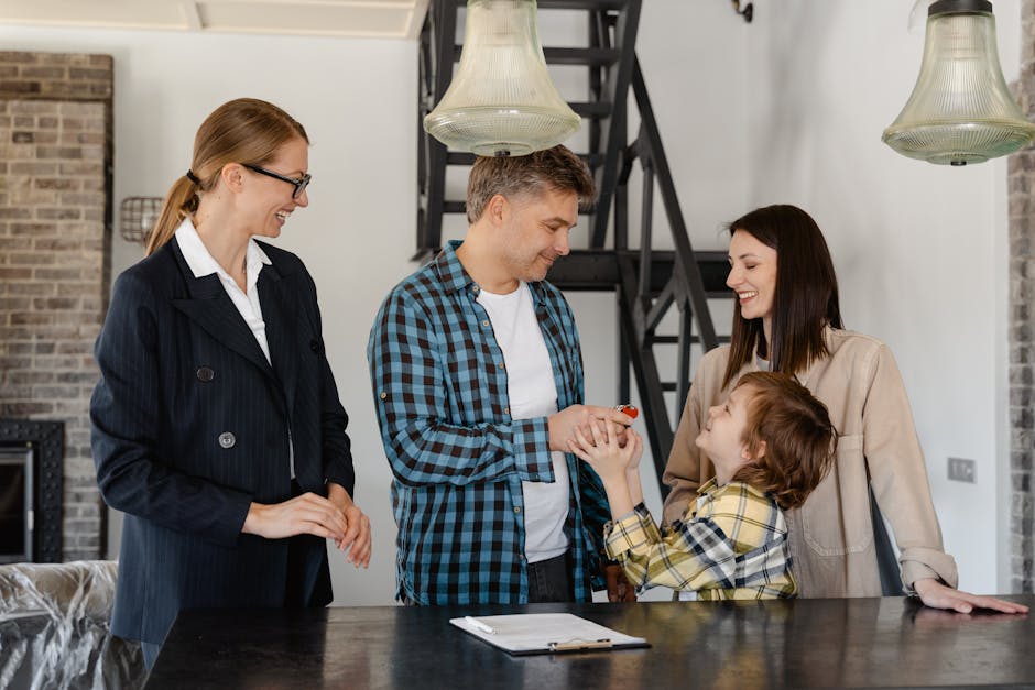 A family celebrates receiving keys to their new home from a real estate agent.
